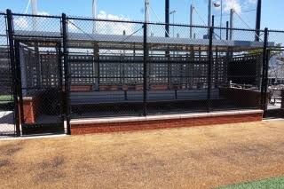 Poured concrete footing and brick base course of the dugout during construction