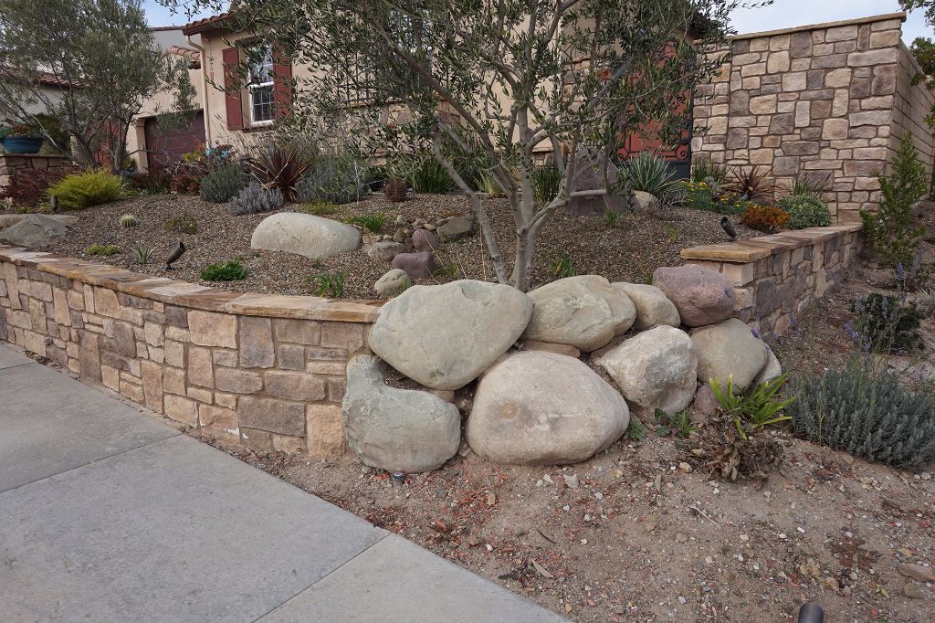 Close on the boulders set into the face of the stacked stone retaining wall, Dos Vientos
