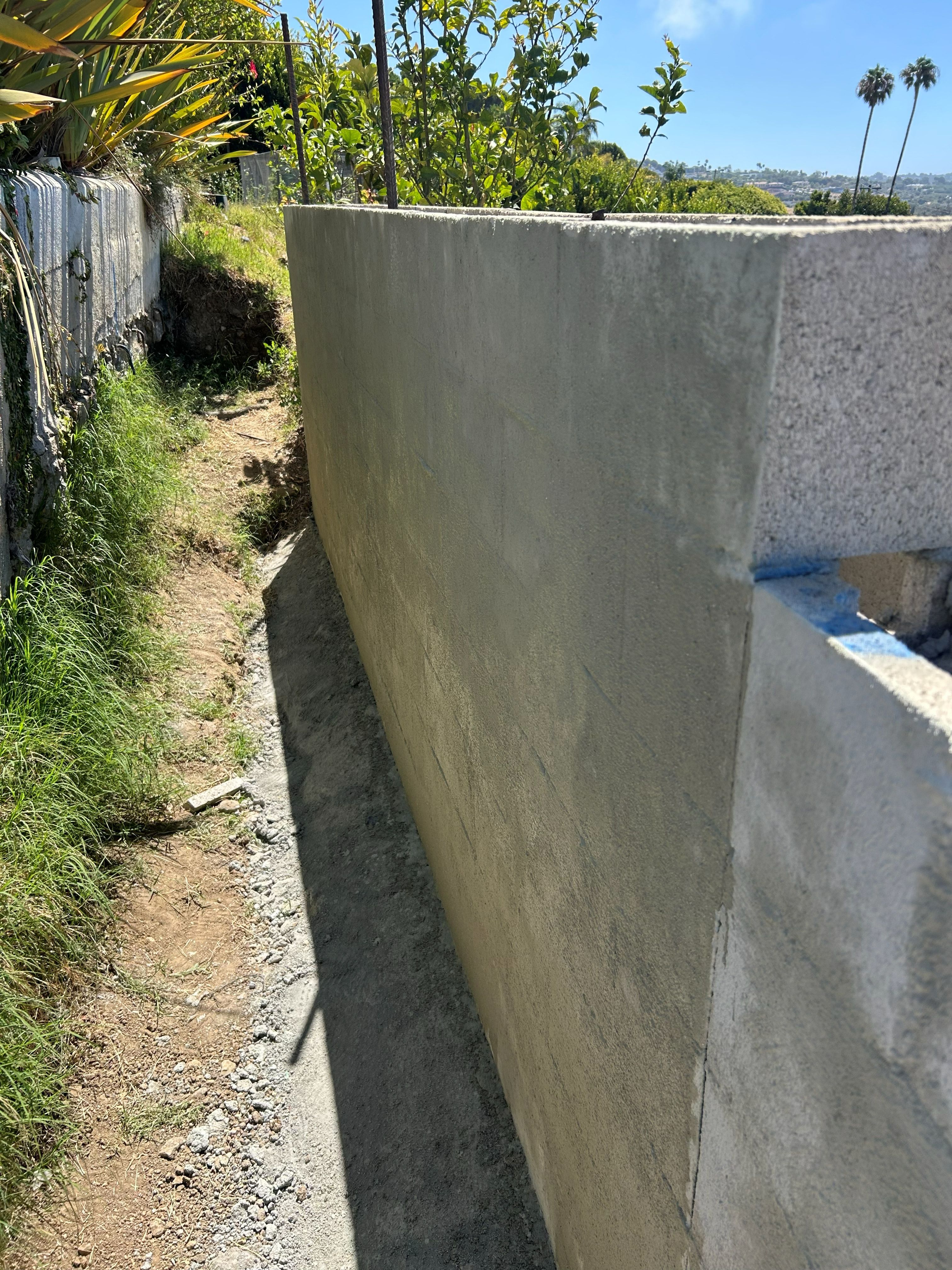 Curved structural retaining wall with the finished face turned to the slope