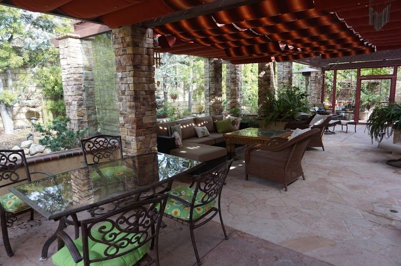 Timber pergola over a natural stone patio in a residential backyard