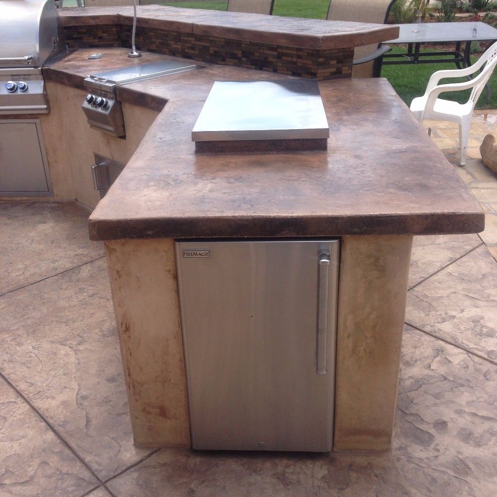 Poured concrete outdoor kitchen counter with a stainless steel built-in