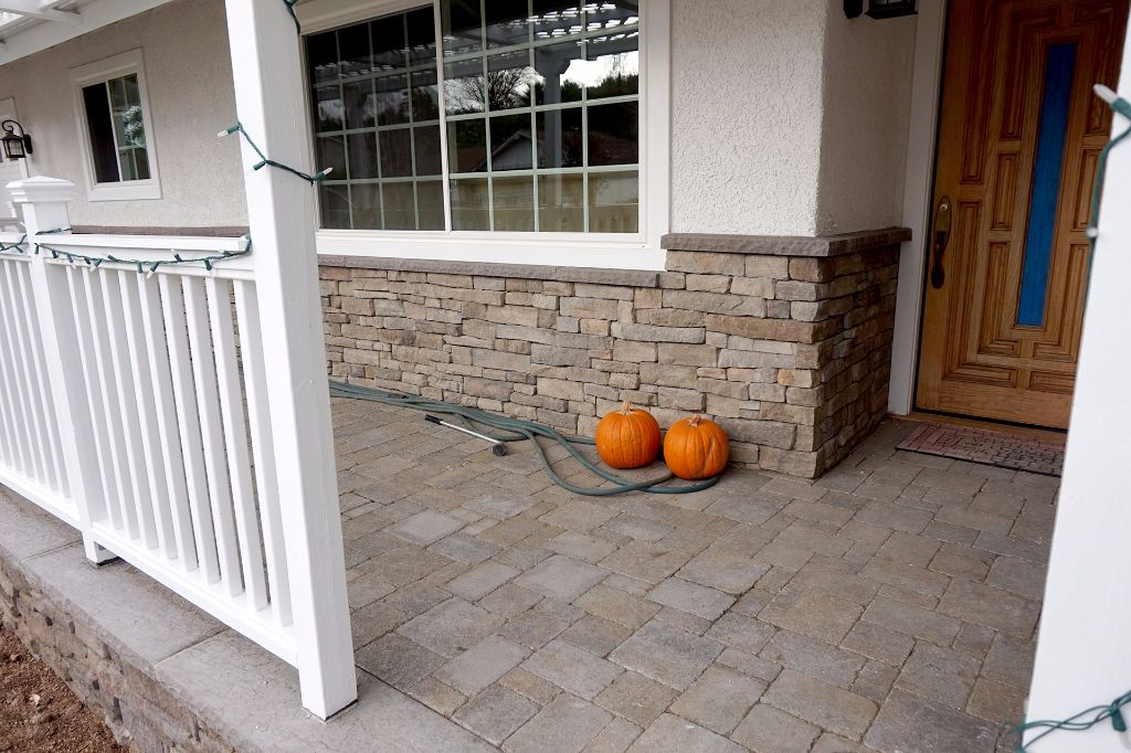 Porch floored in pavers with stone veneer carried up the column bases, Thousand Oaks