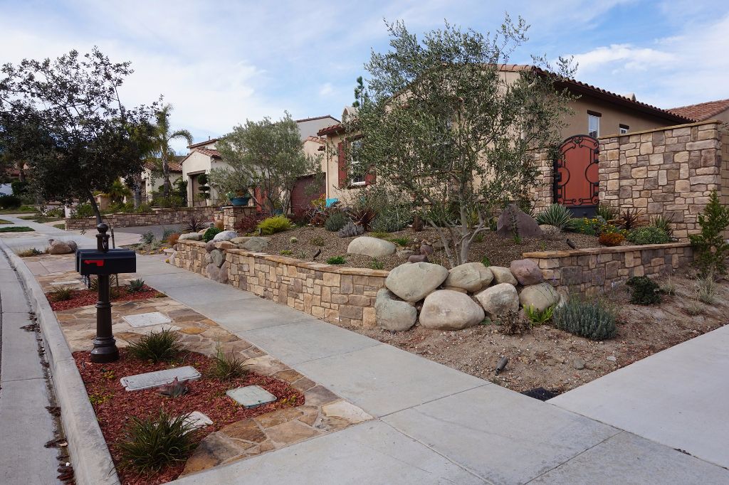 Stacked stone retaining wall with boulders set into the face, Dos Vientos, Newbury Park