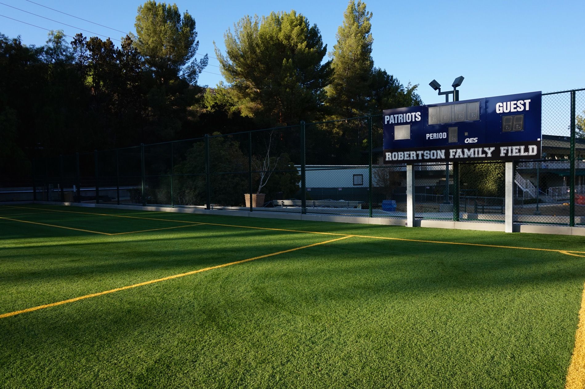 Scoreboard reading Robertson Family Field, standing over the outfield turf at Viewpoint School