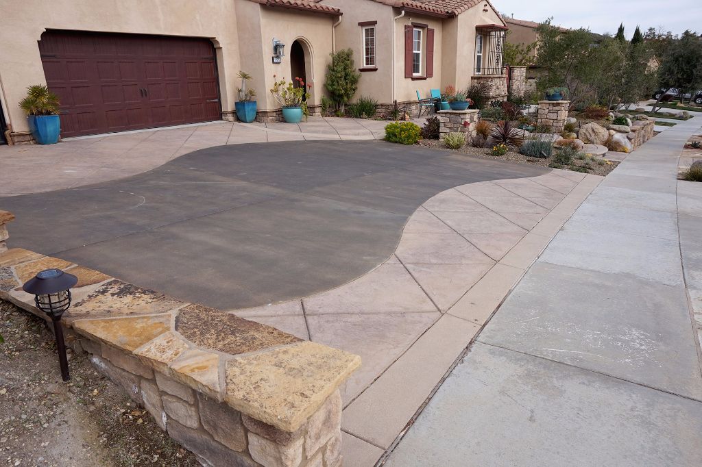 Wide driveway with a stone-faced retaining wall running along the sidewalk, Newbury Park