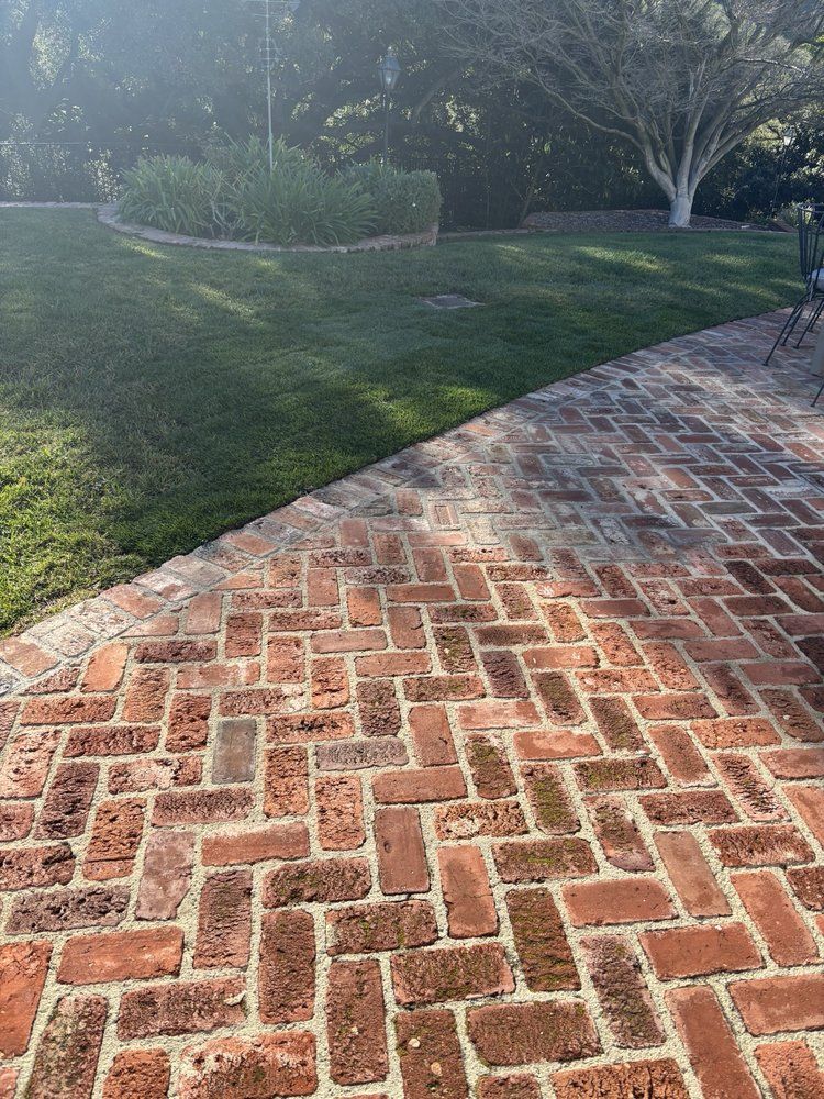 Red brick paving laid in a herringbone pattern, photographed close