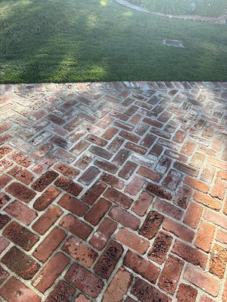 Herringbone brick paving with a damp finish showing the clay color variation