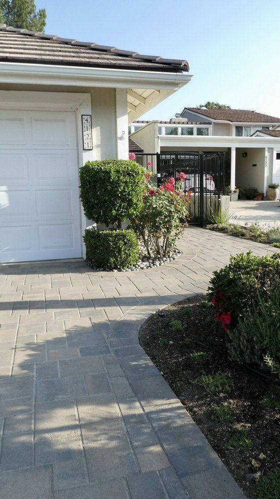Paved driveway apron and walkway at a residential garage
