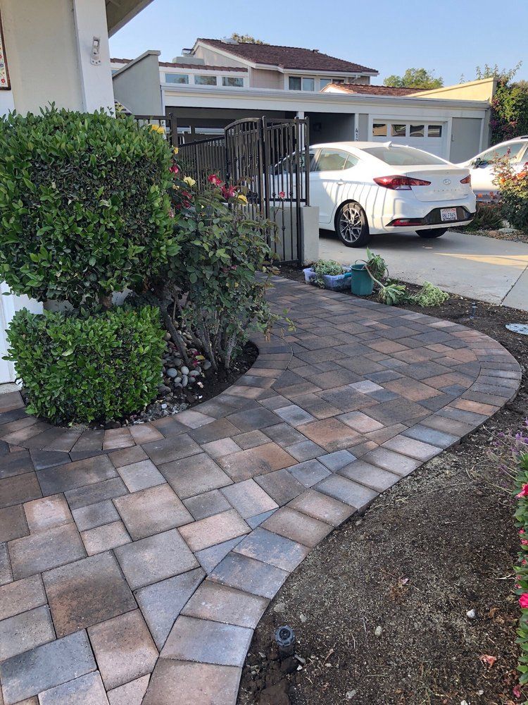 Curved paver driveway sweeping in front of a residence